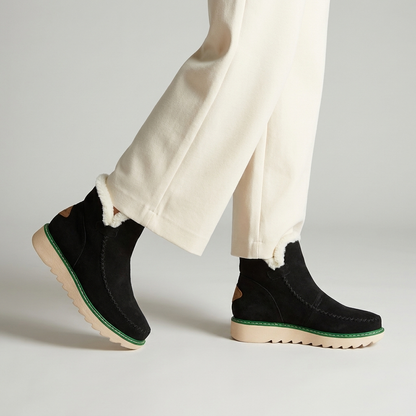 Aurelle boots worn mid stride in studio